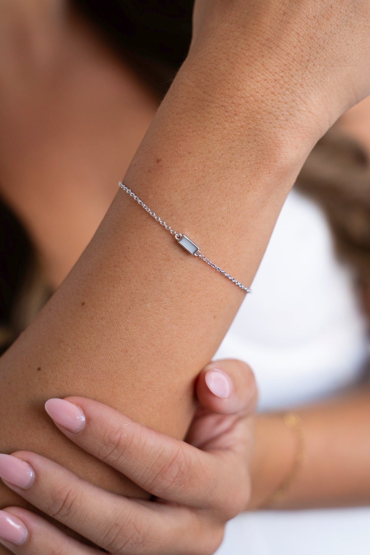 Close-up of the Britt breast milk bracelet in 925 sterling silver with fine links on the wrist.