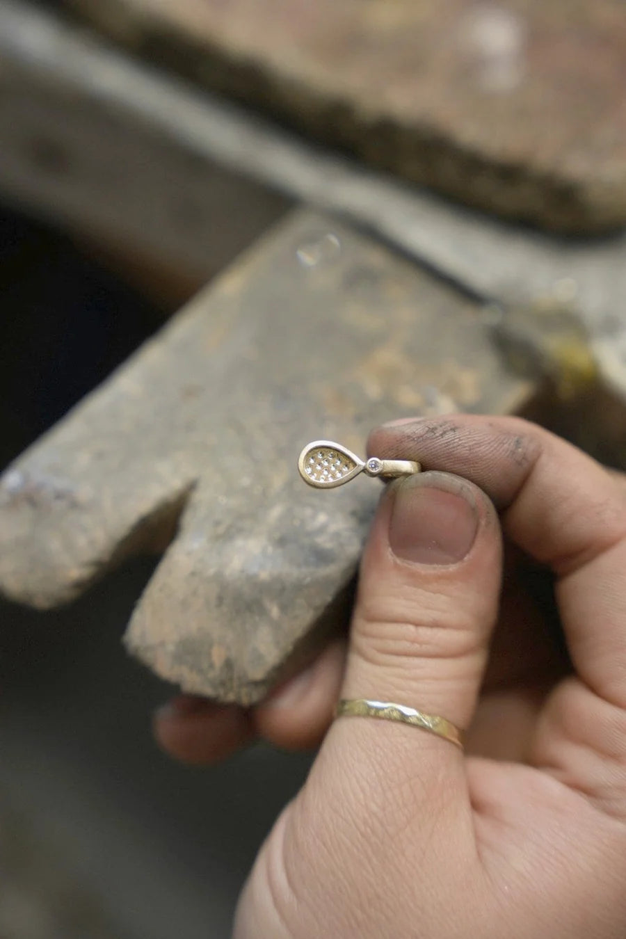 Goldsmith finishing a breast milk pendant by hand
